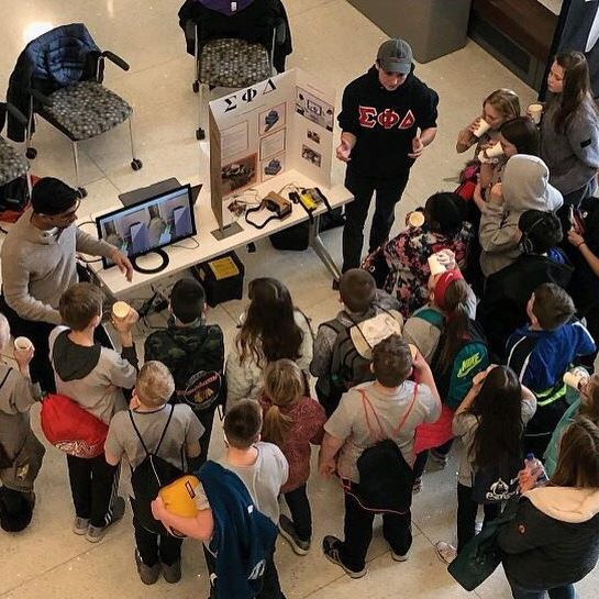 Sigma Phi Delta members collaborating during an engineering project workshop